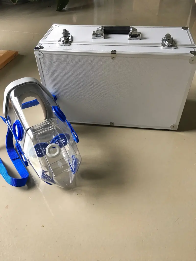 Horse Neb kit: clear nebuliser mask with blue valves beside a plain silver aluminium carry case